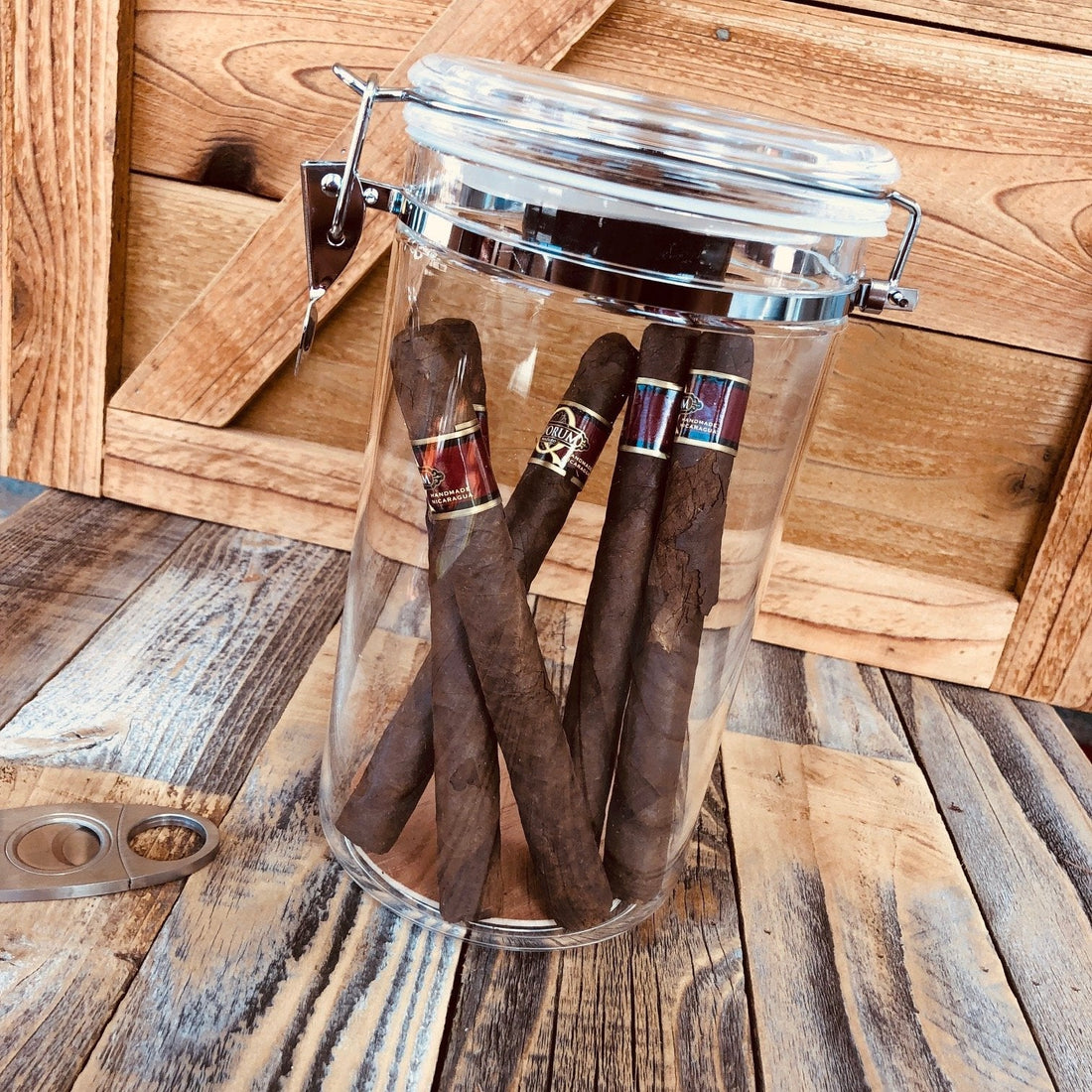 Glass humidor jar holding cigars upright with sealed lid for humidity-controlled storage without a traditional wooden humidor